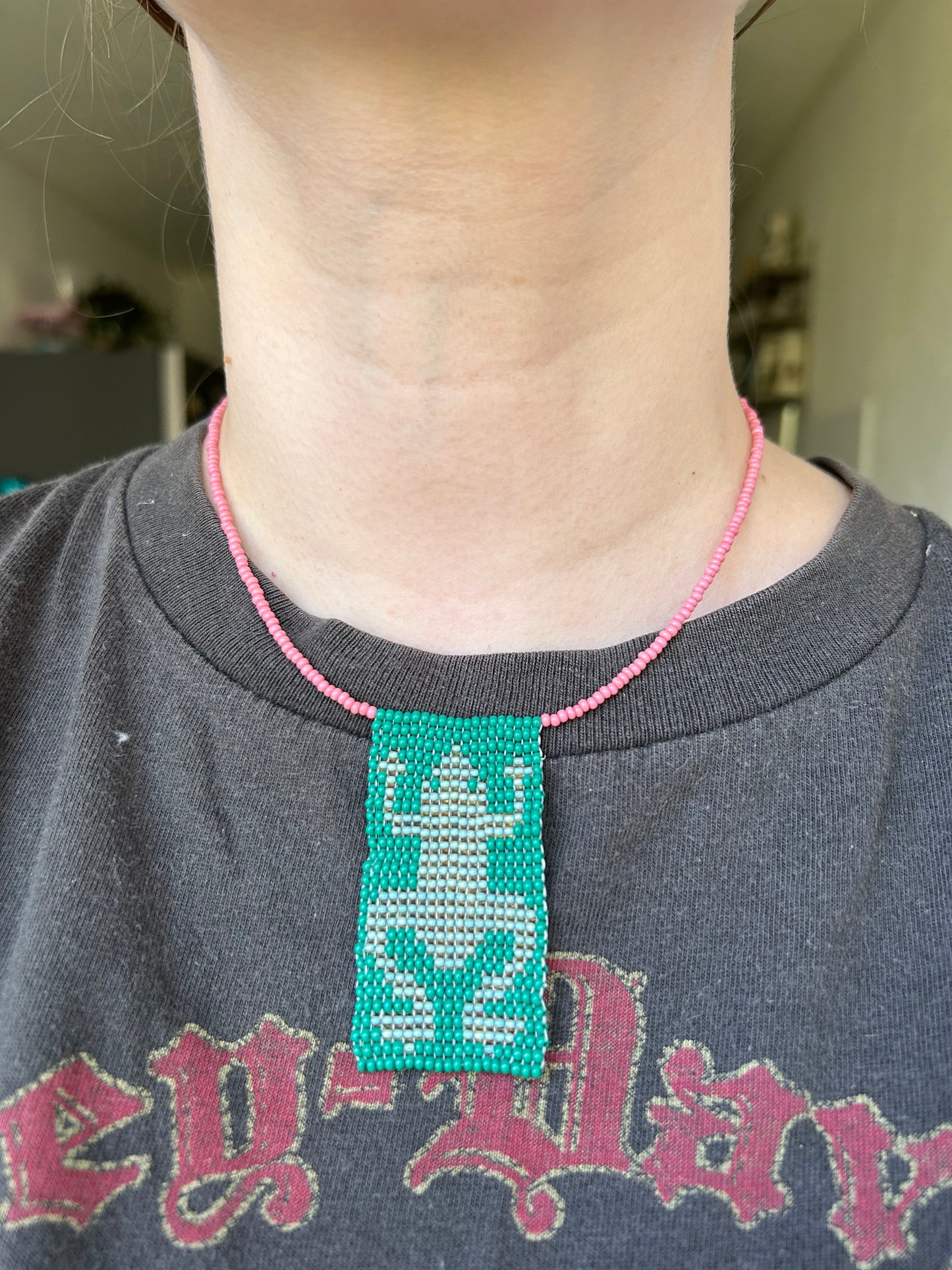 Beaded necklace with a frog pendant.