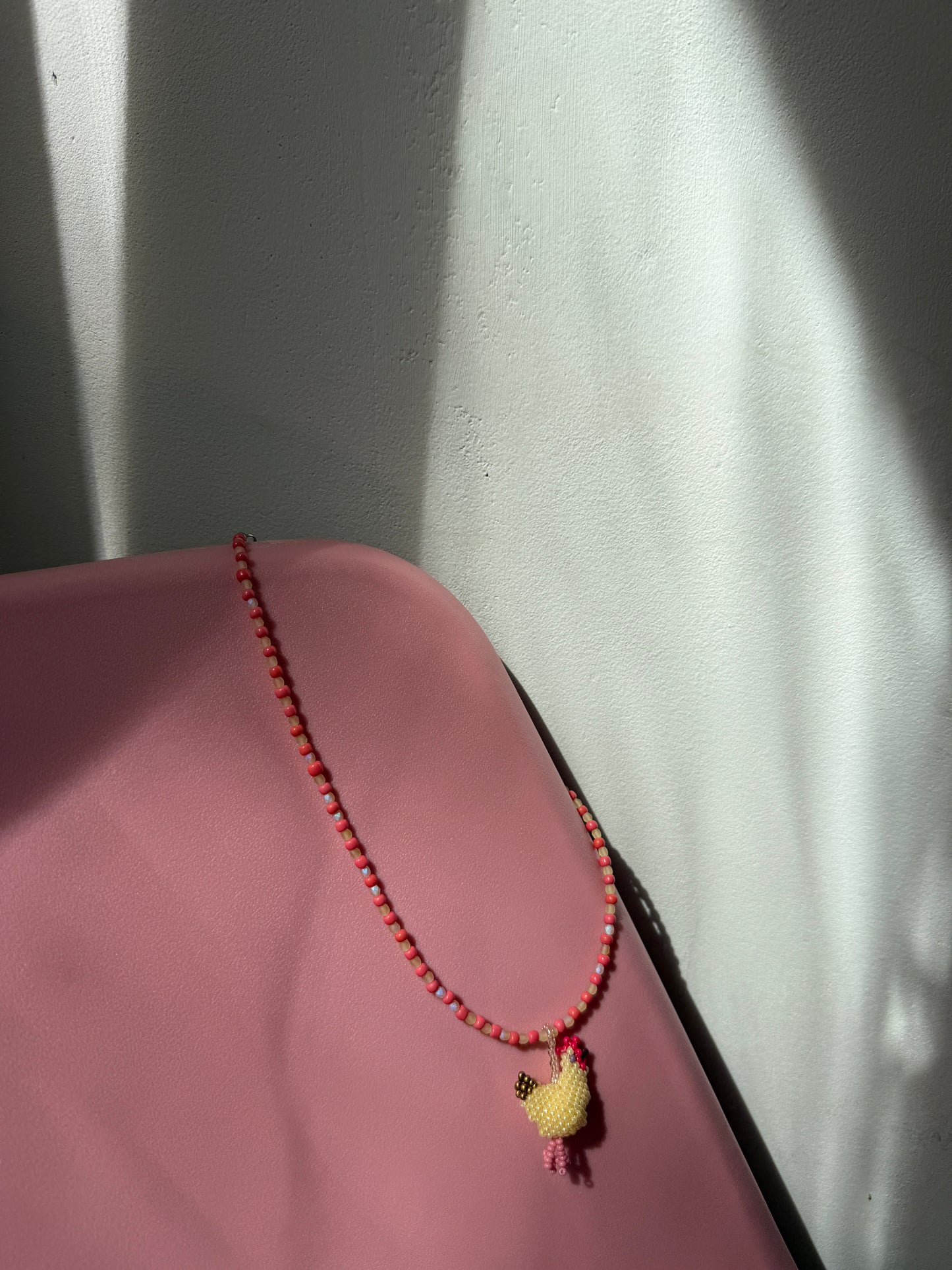 Beaded necklace with a hen