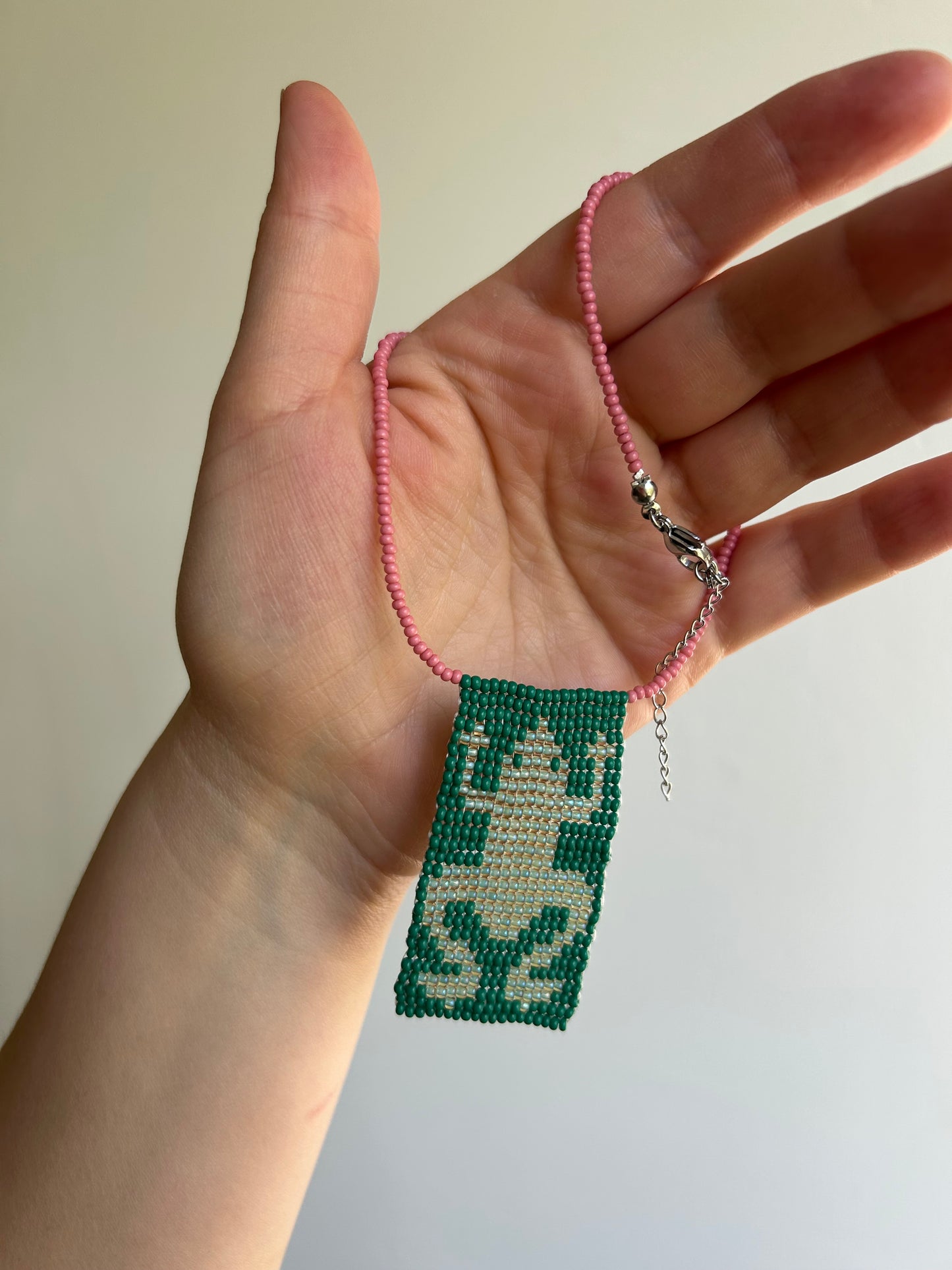Beaded necklace with a frog pendant.