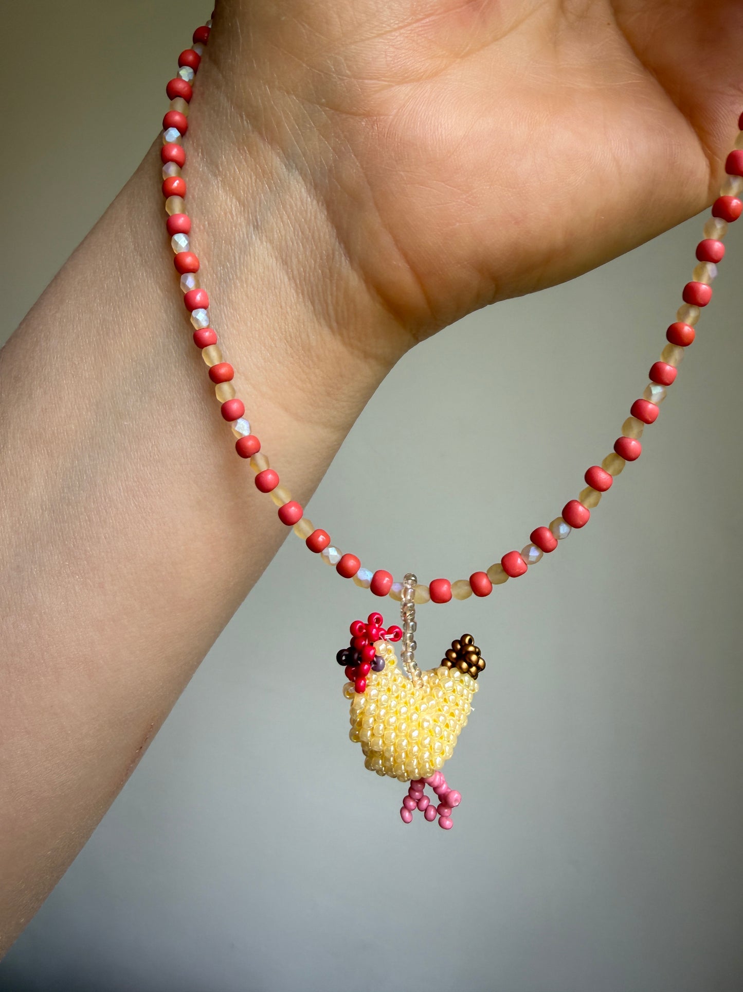 Beaded necklace with a hen