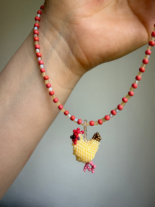 Beaded necklace with a hen