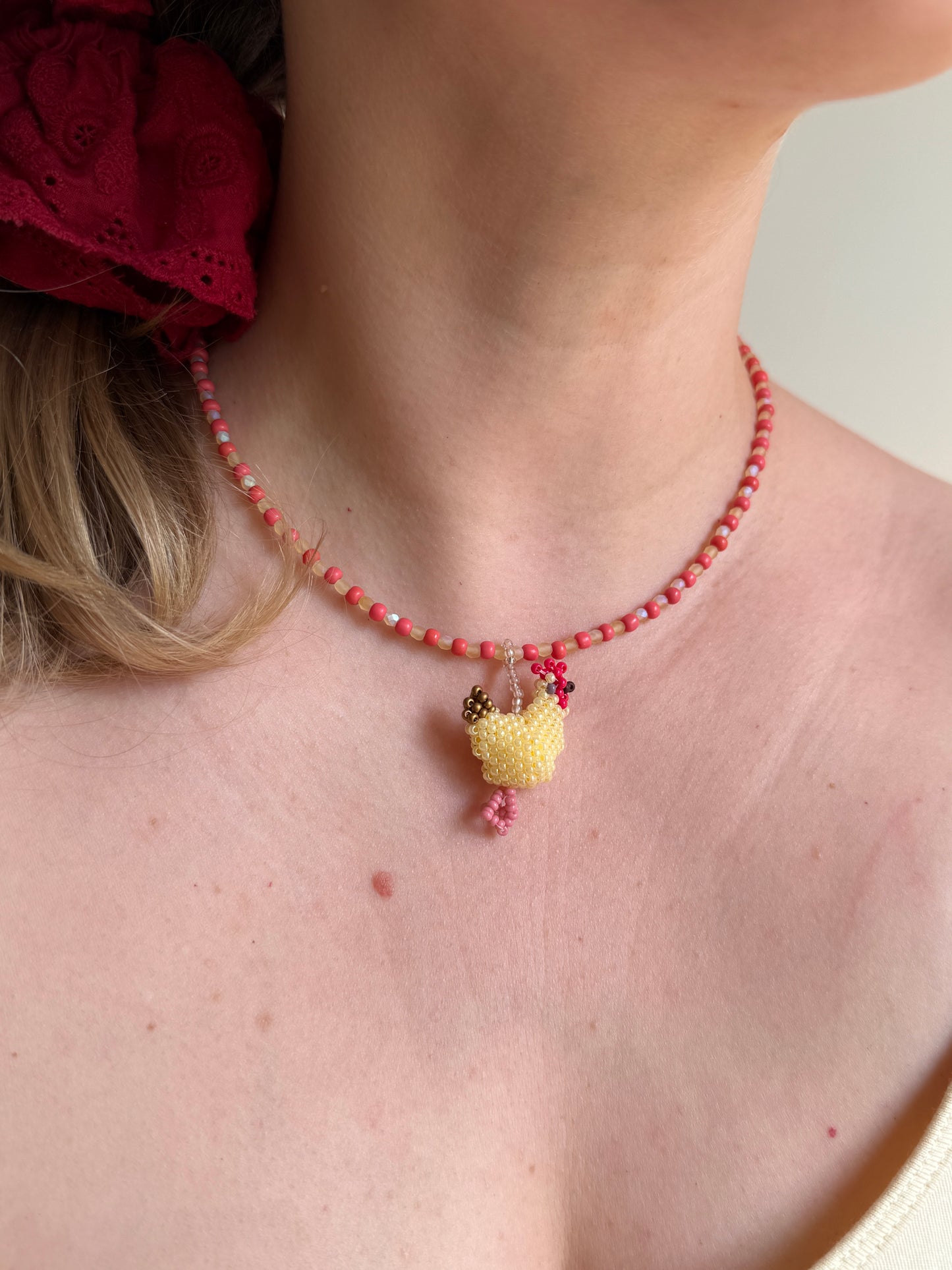 Beaded necklace with a hen
