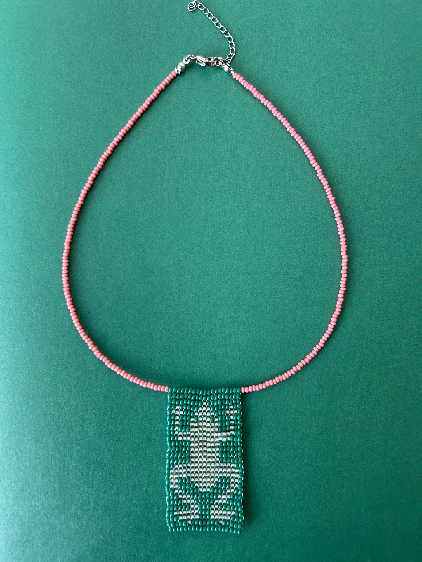 Beaded necklace with a frog pendant.