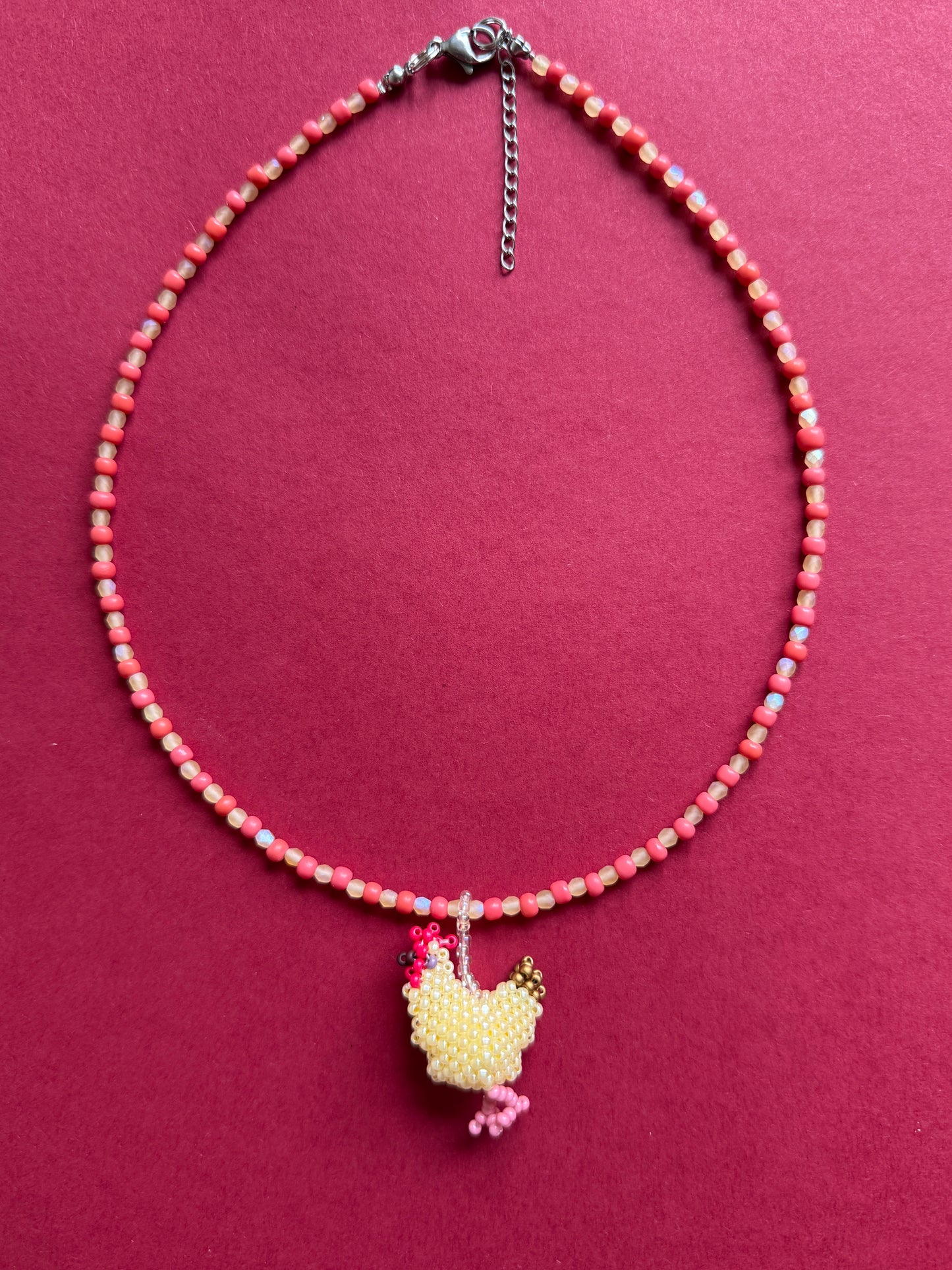 Beaded necklace with a hen